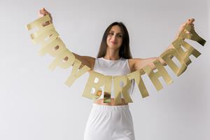 A woman with Happy birthday sign, a Holiday Photo by Kolomiyets Viktoriya