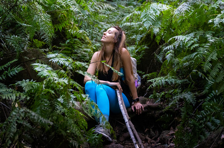 backpacker woman sitting in the jungle sunbathing on her face, a Nature Photo by MnPousa