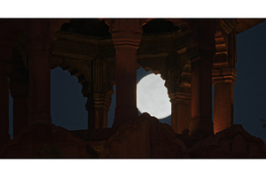 Full moon framed by arches of