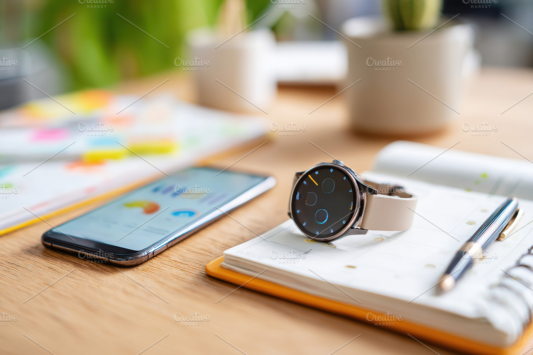 Smartphone and smartwatch on a wooden table with notes and stationery in a mode, a Business Photo by AlyaAnd