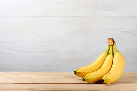 Ripe bananas on brown wooden background, a Food & Drink Photo by AlyaAnd