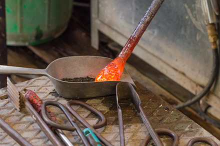 Glass artist in his workshop featuring art, ball, and bead