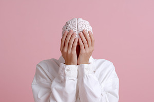 Person holding brain model, a Health & Medical Photo by MistyDay