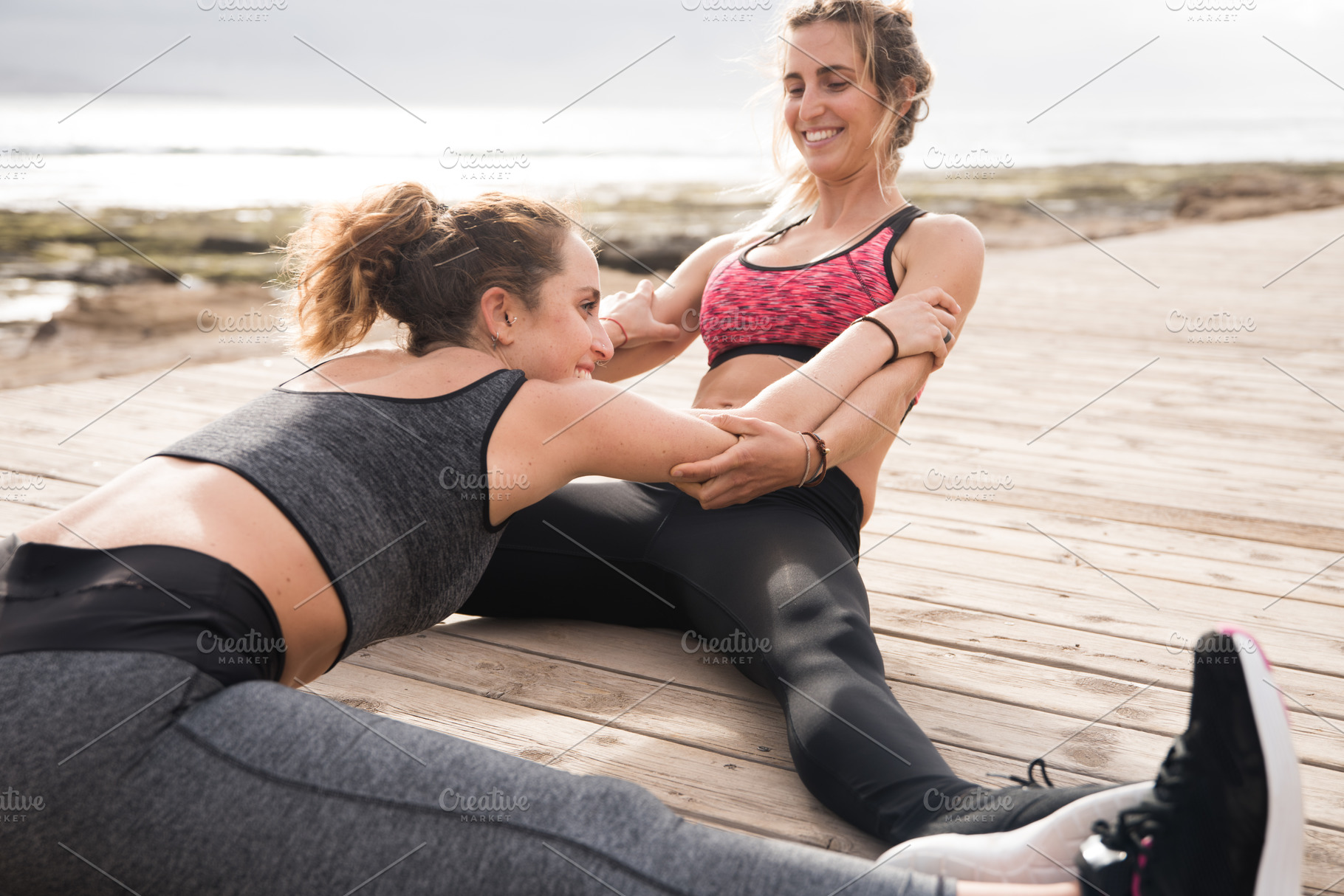 Two young healthy girls excercising, a Person Photo by Coco Images