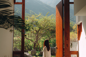 Woman in doorway, mountain view, a Photo by Beautiful things