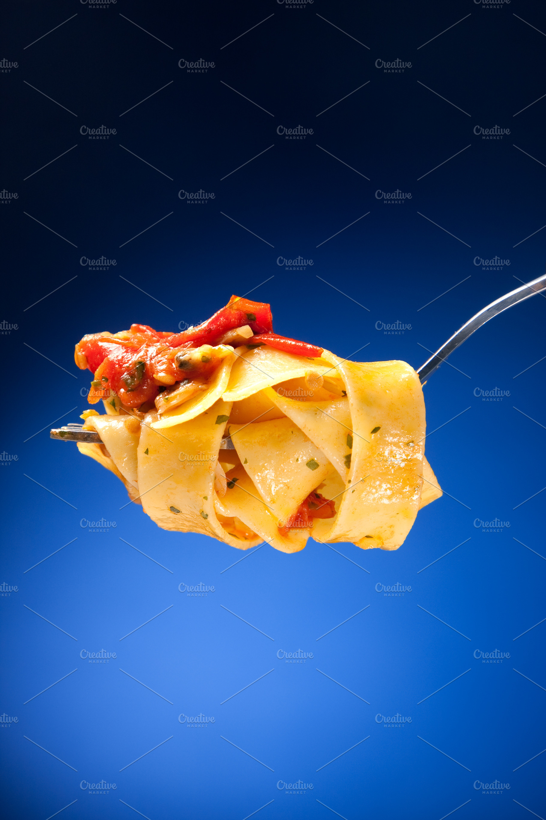 Tagliatelle with clams on a red background, a Food & Drink Photo by FoodStock