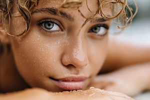 Close up of a young woman with curly, a Person Photo by MistyDay