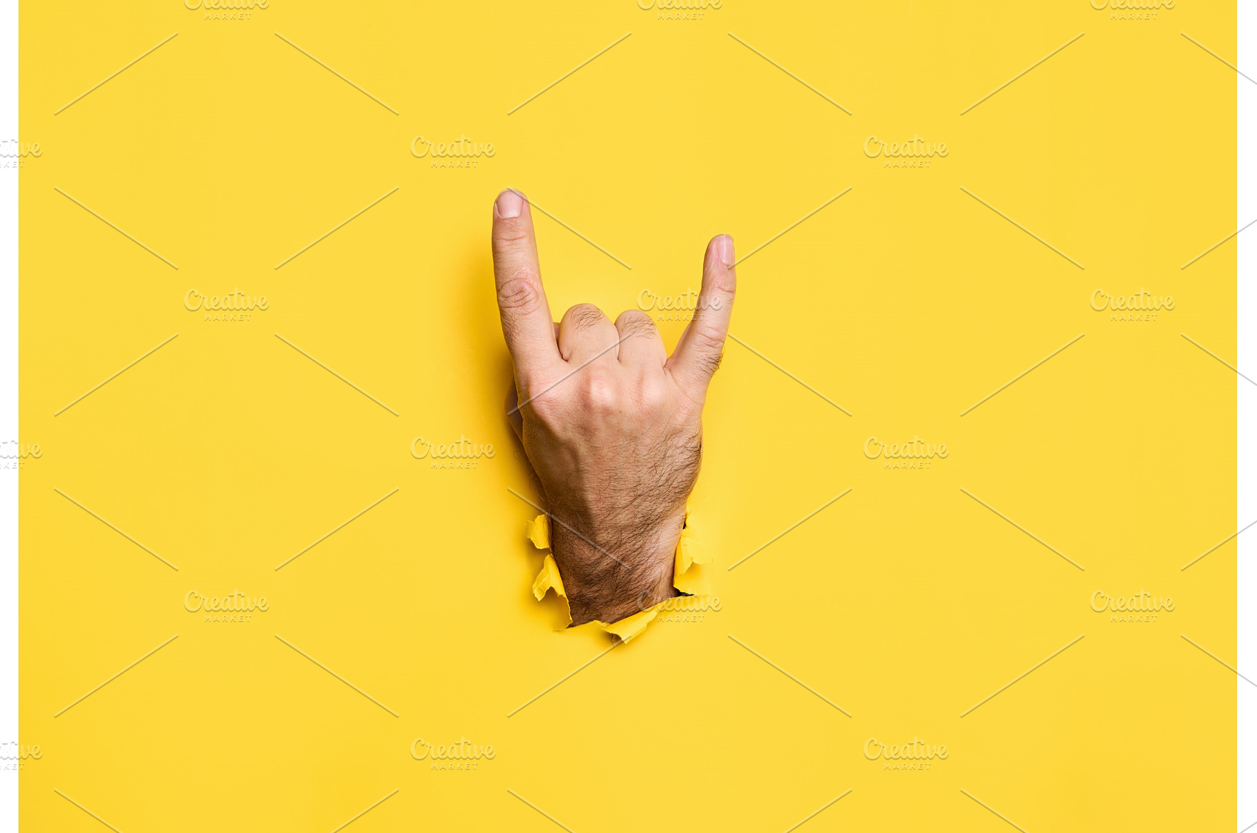 Rock sign gesture through hole in, a Person Photo by Gladkov photography