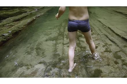 Boy walks in water in forest, a Person Photo by Media Whale Stock
