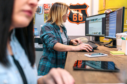 Blonde young woman checking orders in a computer received by ecommerce shop, a Person Photo by davidpereiras