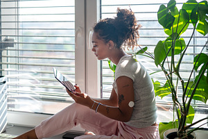 Woman using digital tablet during, a Person Photo by HalfPoint