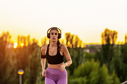 Young woman running at sunset with h, a Sports & Recreation Photo by Perpis