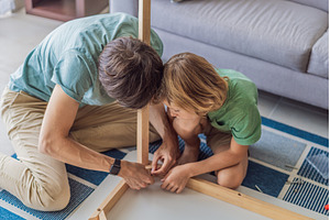 Father and his son assembling a, a Person Photo by Elizaveta Galitskaya