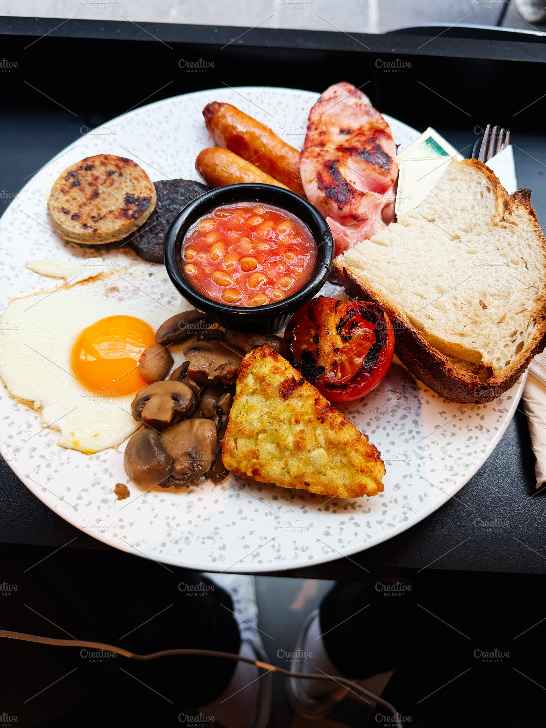 Full Irish breakfast plate with fried egg sausages baked beans t, a Photo by AS photostudio