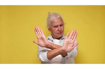 Senior European woman showing a stop, a Business Photo by Koldunova