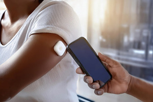 Person scanning a medical patch with smartphone