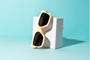 Sunglasses on white podium with, an Arts & Entertainment Photo by Nadia-nb