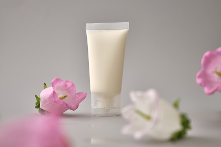Skincare products on neutral background. Mockup bottles and flow