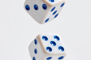 Floating white dice with blue dots captured in motion during a gaming session, a Sports & Recreation Photo by AlyaAnd