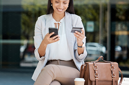 Online shopping, credit card and business woman on her phone in city. Tech, urban and happy girl using smartphone for online banking, internet and cyber shopping on online store, bank card in hand, a Photo by Peopleimages.com
