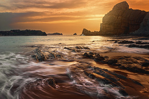 Golden sunset on a rocky coast with, a Nature Photo by Perpis