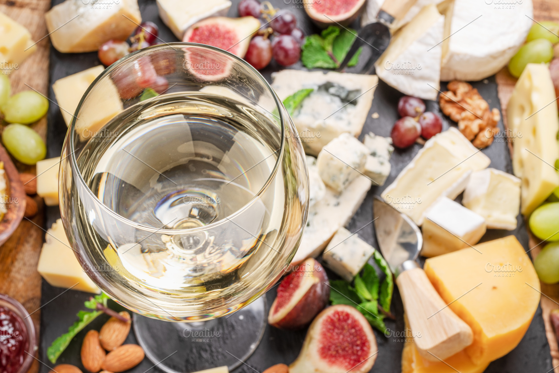 Glass of white wine with cheeses., a Food & Drink Photo by Volff