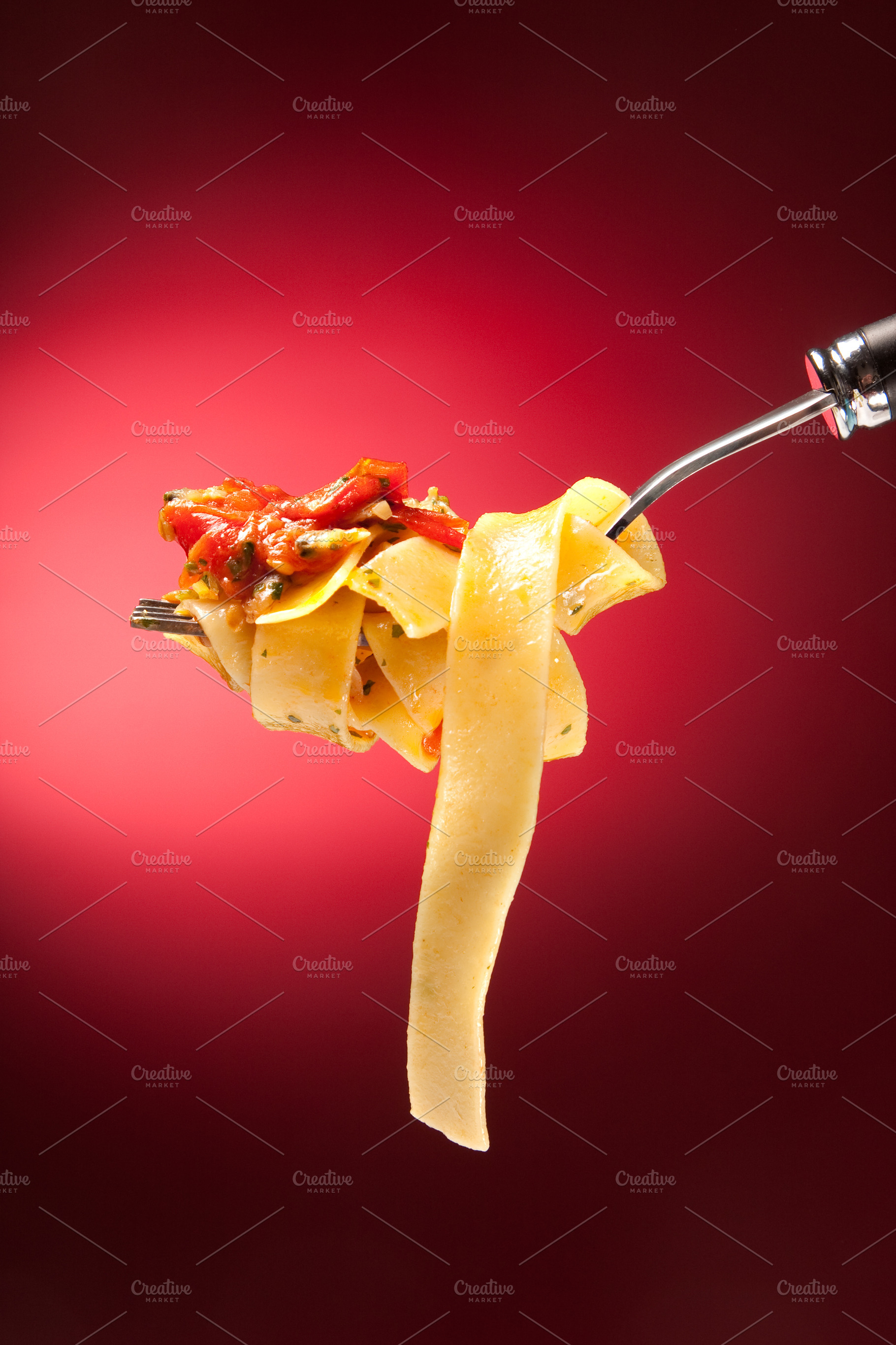 Tagliatelle with clams on a red background, a Food & Drink Photo by FoodStock