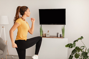 Sporty Woman Doing Leg Exercise During Workout At Home, a Photo by Prostock-Studio