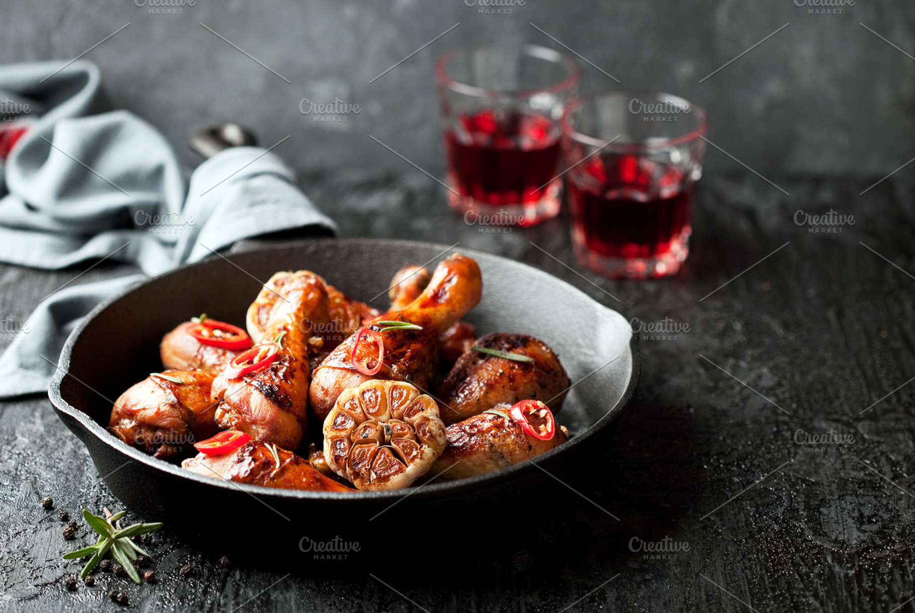 Roasted chicken legs in cast iron skillet, a Photo by Y. A. Photo