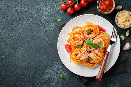 Tasty appetizing classic italian tagliatelle pasta with tomato sauce, cheese pa, a Food & Drink Photo by Budarinphoto