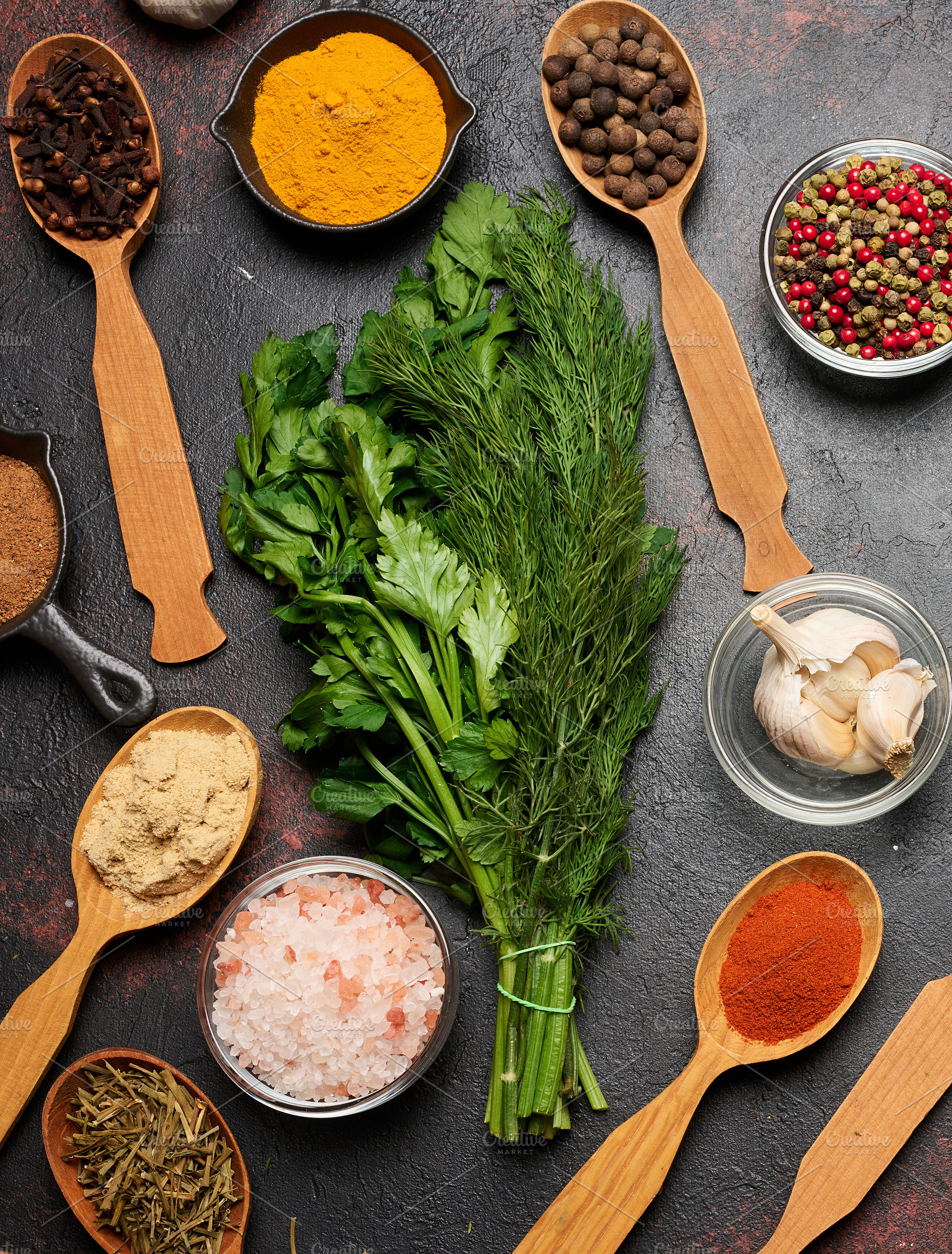 Spices, herbs, and garlic on a dark background. Turmeric, paprik, a Food & Drink Photo by ndanko