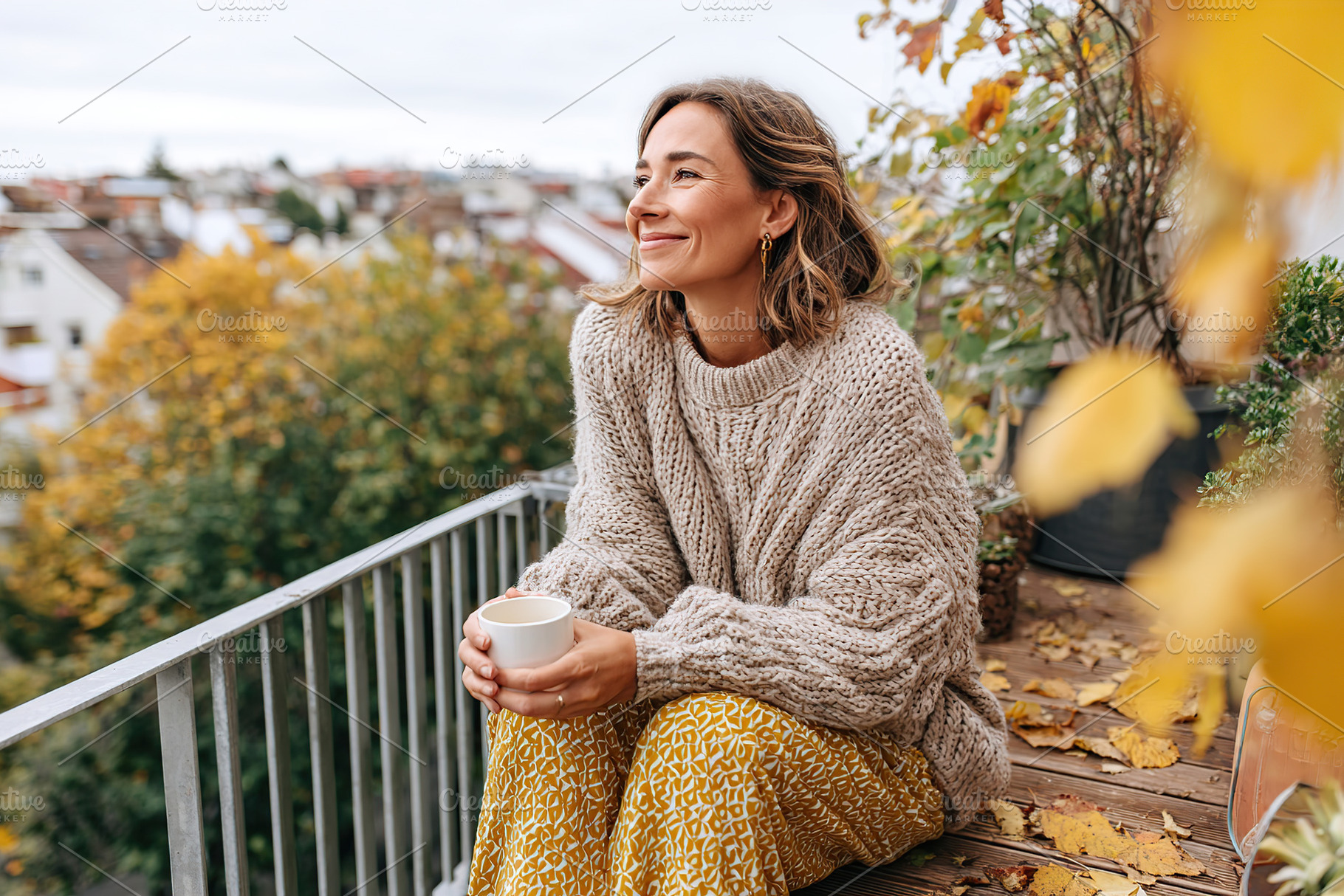 Enjoying warm tea on a cozy balcony while wrapped in loose clothing during autu, a Person Photo by AlyaAnd