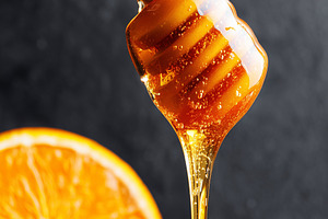 Golden honey dripping from a wooden, a Food & Drink Photo by MistyDay