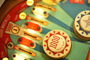 Vintage pinball machine lit up, an Arts & Entertainment Photo by Serifs & Whiskey
