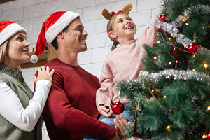 Happy family decorating Christmas tree together, a Person Photo by etorres69