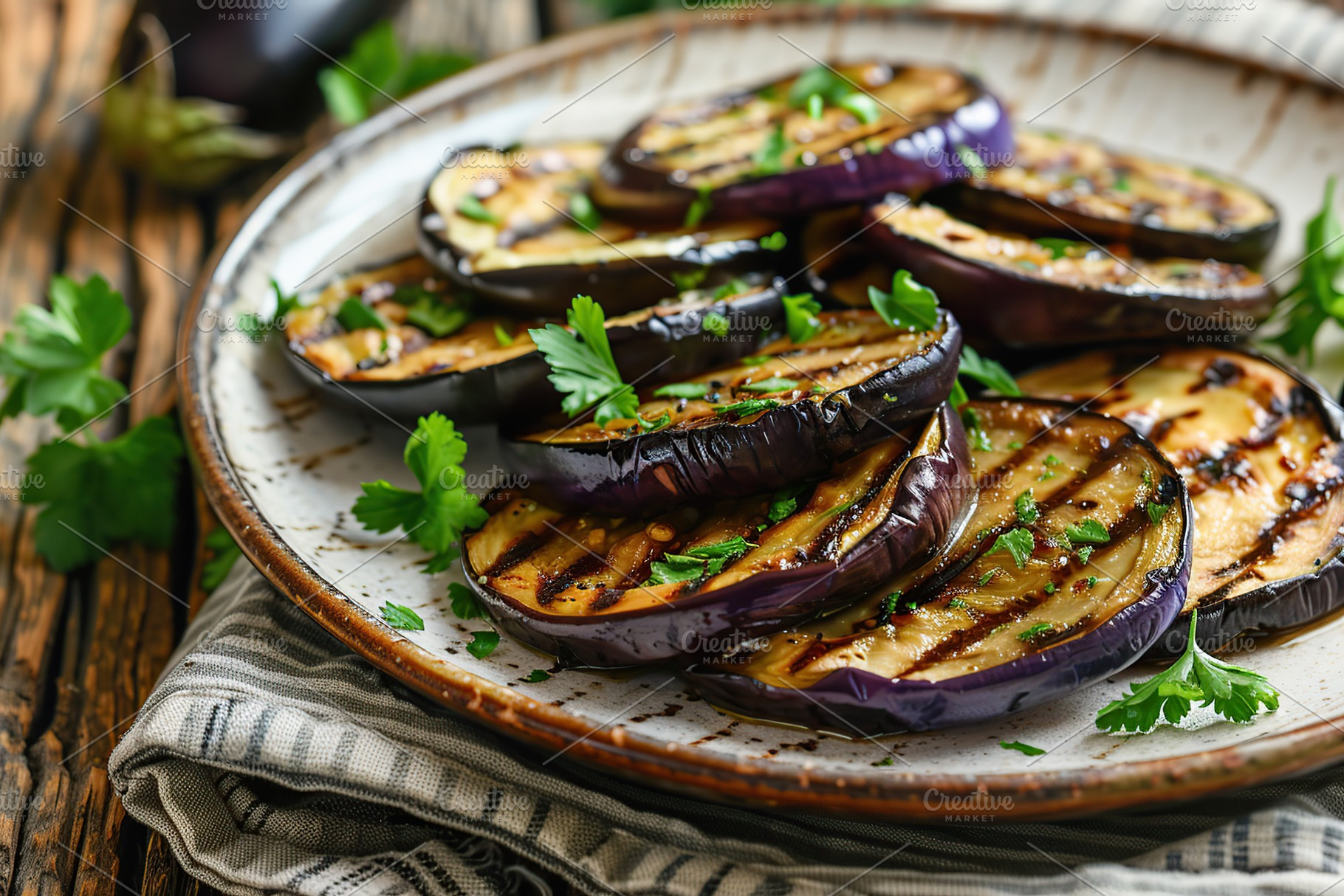 Slices of grilled eggplants in plate on wooden table, a Food & Drink Photo by AlyaAnd