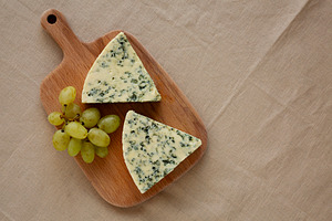 Delicious Cheese Danablu on a wooden board, top view. Copy space, a Food & Drink Photo by LiudmylaChuhunova