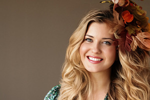 Beautiful woman smiling, wearing autumn leaves in her long wavy, a Person Photo by Studio ANNA