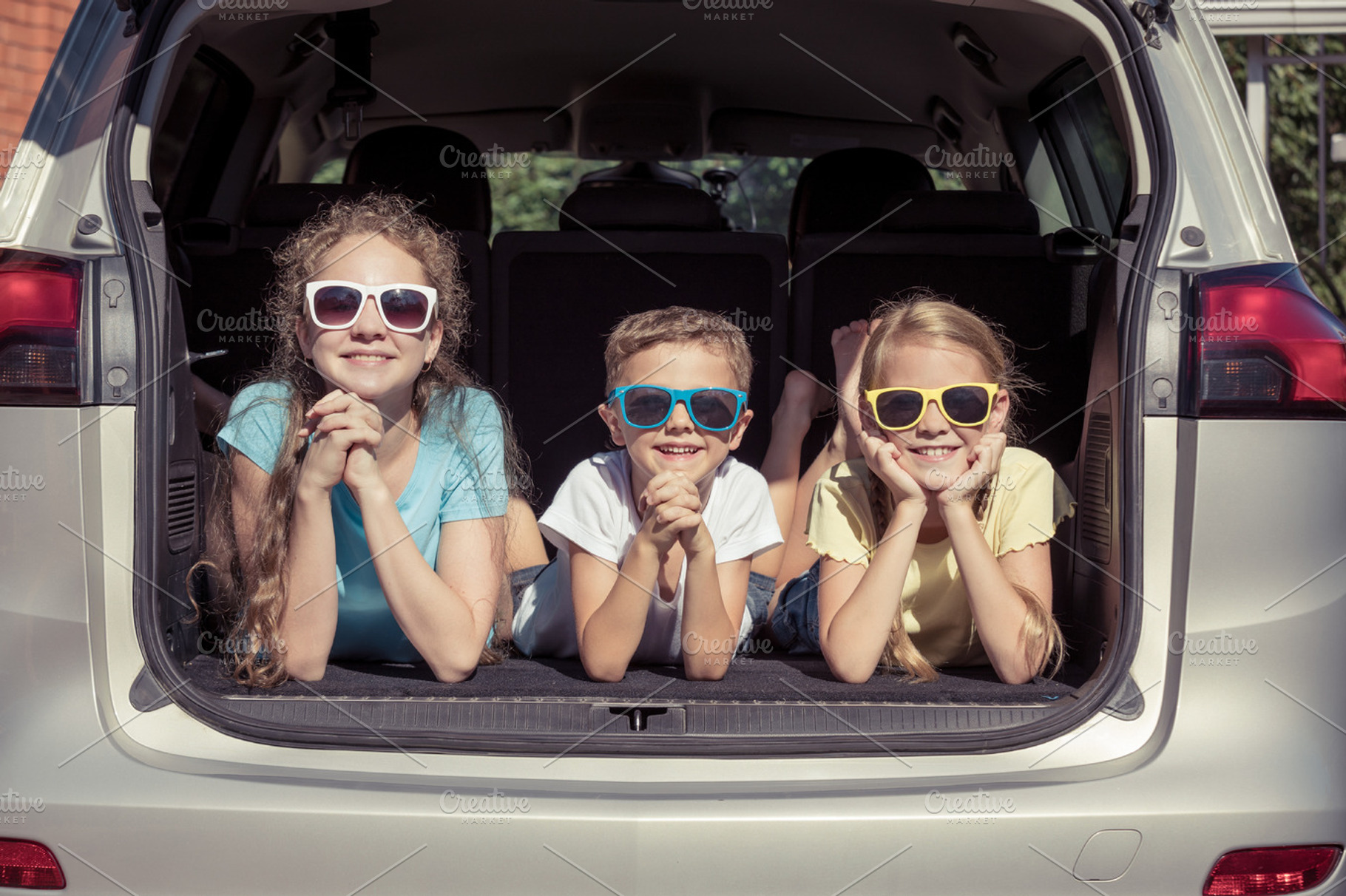 Happy kids sitting in the car stock photo containing car and child, a Person Photo by altanaka
