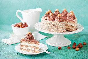 Meringue hazelnut cake with chocolate cream containing closeup, decoration