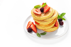 Pancakes stacking with strawberries, blackberries, and mint, a Food & Drink Photo by Olena Rudo