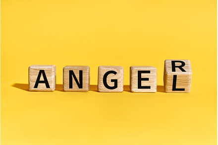 Wooden blocks forming words ANGEL to