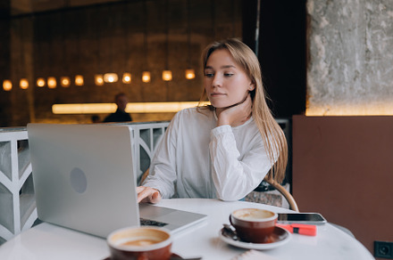 Young lady browsing the Internet at the cafe
