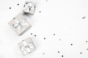 Silver gifts and confetti on white, a Holiday Photo by Anna Efetova