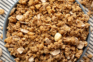 Healthy Homemade Toasted Muesli with Nuts in a Bowl, top view. C, a Food & Drink Photo by LiudmylaChuhunova