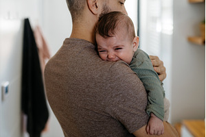 Father comforting his crying baby, a Person Photo by HalfPoint