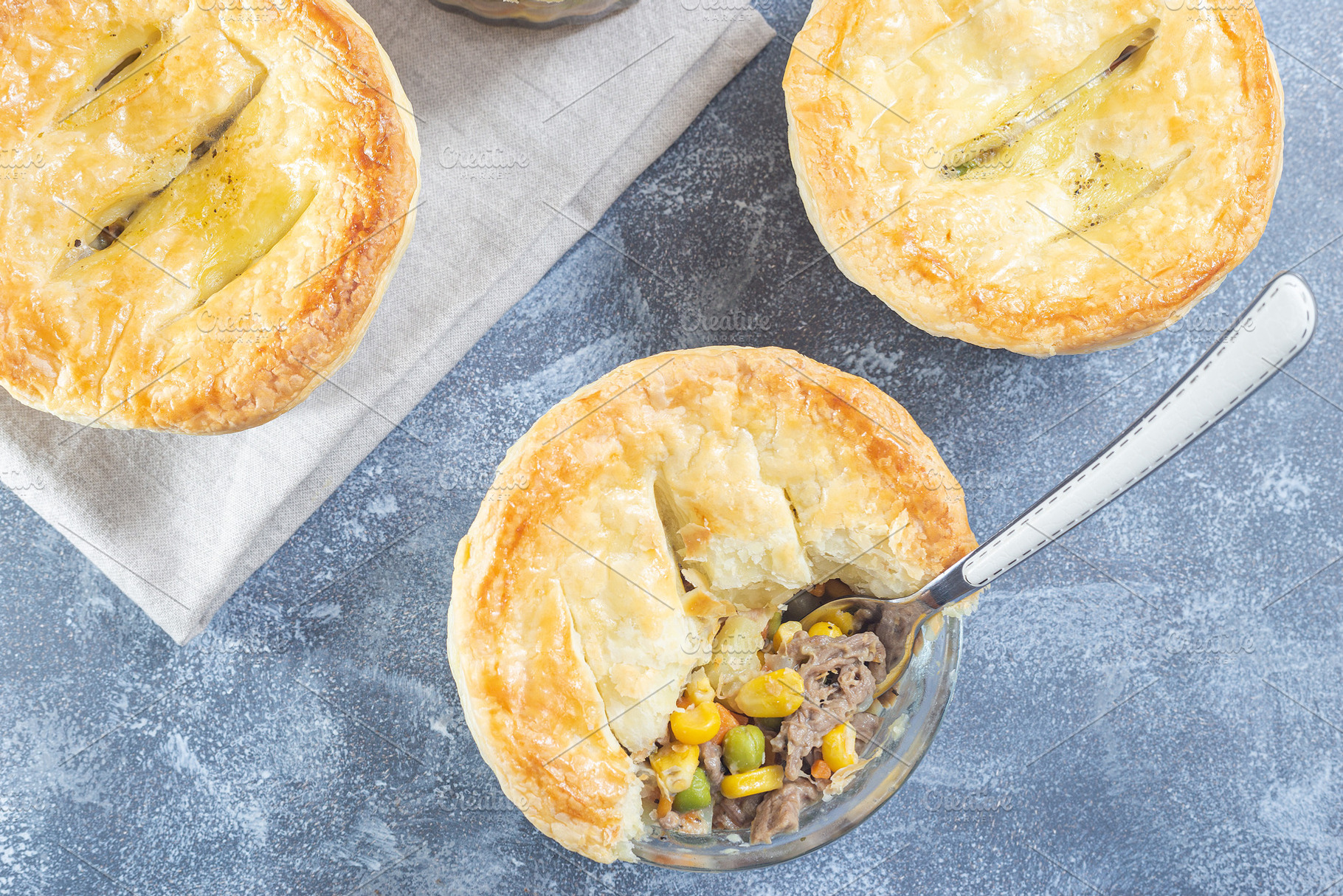 Small beef pot pie or deep dish pie in ramekin, crust broken open, horizontal,, a Food & Drink Photo by iuliia_n