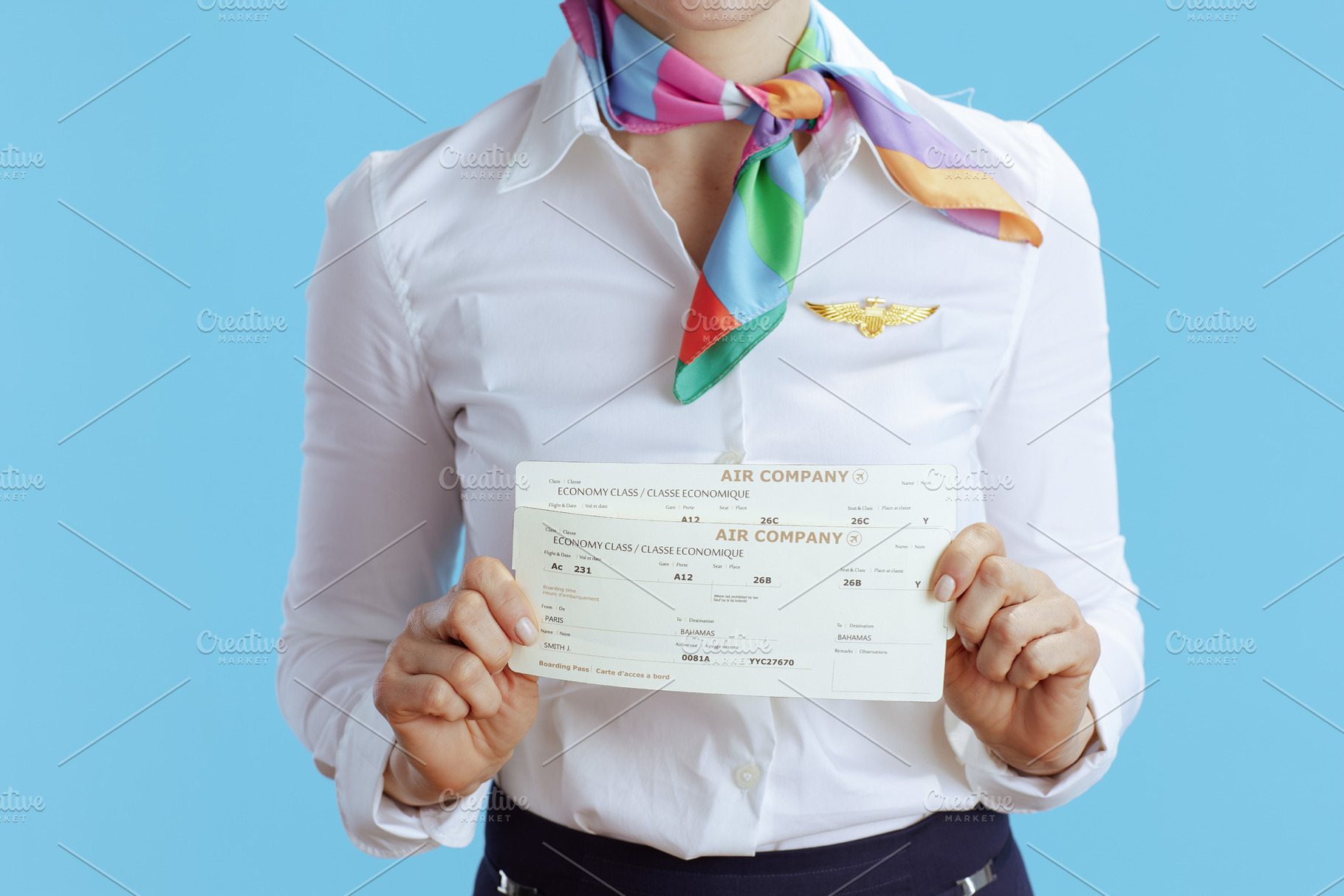 Closeup on flight attendant woman on blue, a Business Photo by Alliance Images