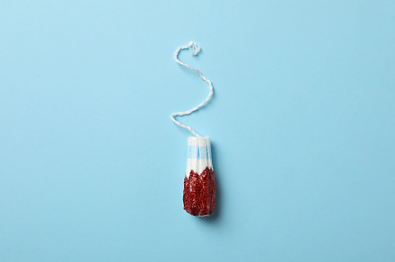 Used tampon on blue background, space for text, a Health & Medical Photo by AtlasStudio