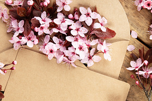 Cherry Blossoms in Kraft Envelope on Rustic Wooden Table, a Holiday Photo by Natalia Klenova's Shop